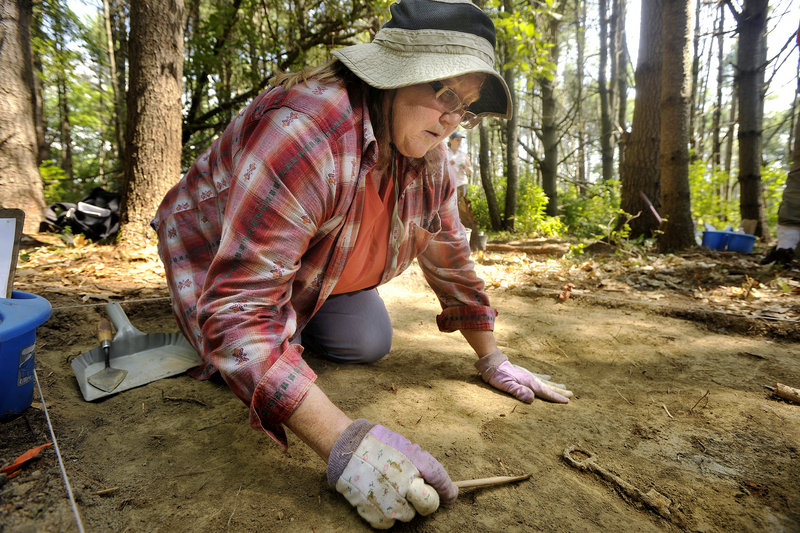 Mary Cook of Orrs Island unearths a key Tuesday during the first archaeological field school hosted by the Freeport Historical Society on Grant’s Point. The dig focuses on an area where Abraham and Susannah Grant lived in the late 1700s and early 1800s.