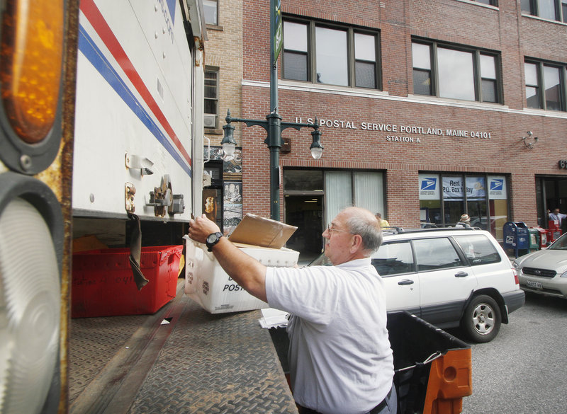 A postal worker loads a truck at the Station A Post Office on Congress Street in Portland on Tuesday. The branch was also listed for closure last year, but public response kept it open.
