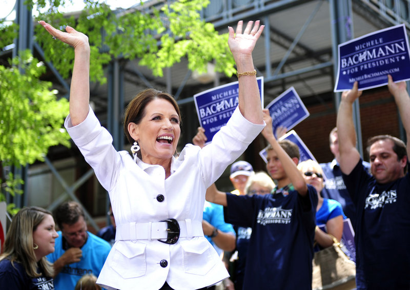 Rep. Michele Bachman, R-Minn., acknowledges the crowd at a rally last week in downtown Aiken, S.C. Often critical of government subsidies, her personal finances have come under scrutiny for accepting farm and business subsidies.