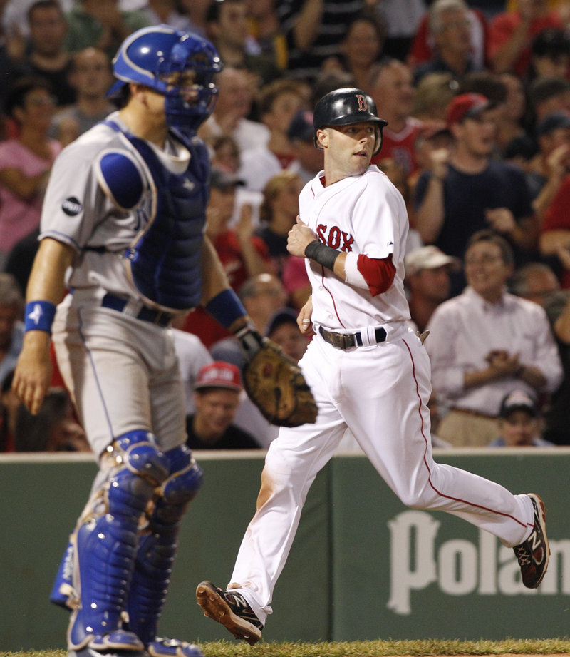 Dustin Pedroia scores on a double by David Ortiz as Royals catcher Matt Treanor looks on during Boston’s 13-9 win over Kansas City on Tuesday. Pedroia finished a home run shy of hitting for the cycle.