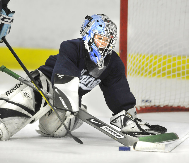 Sam Tibbetts blocks a shot while working on his goaltending technique. Tibbetts is one of 52 boys and girls attending the morning and afternoon sessions.