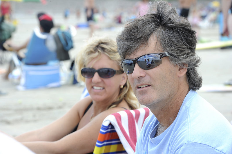 Sue-Anne and Scott Rae of Montreal spend time at Ogunquit Beach last week. Maine's beaches are so popular among Canadians that radio stations where they live air York County weather forecasts, the Raes said.