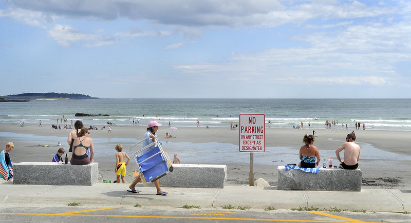 A sparse crowd takes in a spectacular day last week at Higgins Beach in Scarborough. Scant parking has always limited public access to the beach, which is fronted by private landowners but used by the public since the 1800s.