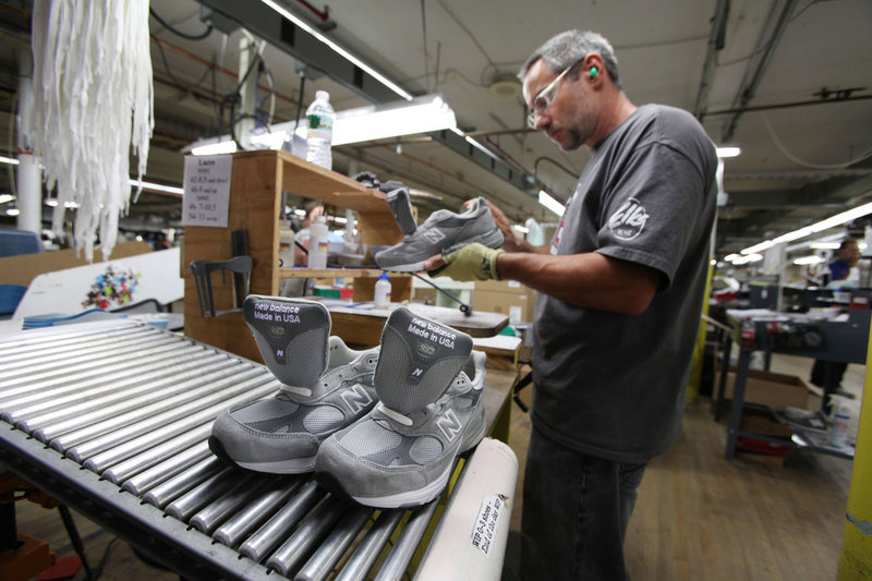 Kirby Knox inspects a shoe at the New Balance factory in Norridgewock. Knowing that the company could make far more money if, like Nike and Adidas, it shifted most of its jobs to low-wage countries, Maine workers try to make up the difference through efficiency.