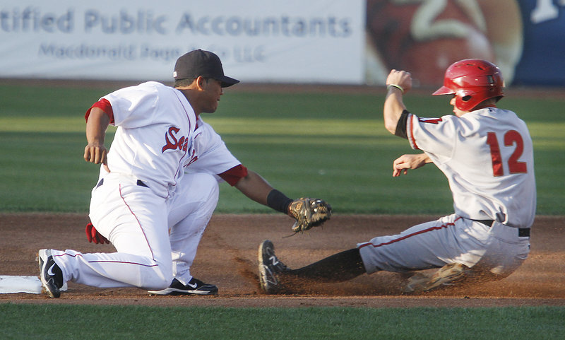 Heiker Meneses of the Portland Sea Dogs prepares to slap a tag on Brock Holt of the Altoona Curve, who was caught attempting to steal second base Thursday night in the first inning of Altoona’s 7-4 victory at Hadlock Field.