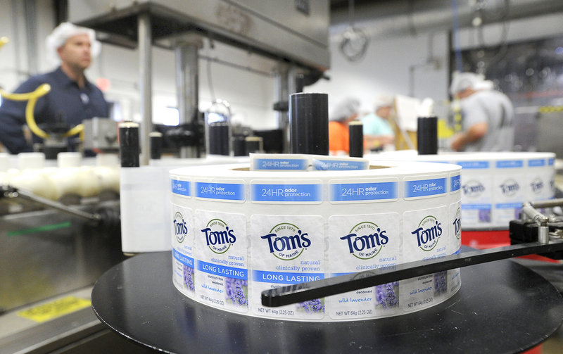 Labels are affixed to deodorant bars at Tom’s of Maine in Sanford. The company’s first product was laundry detergent.