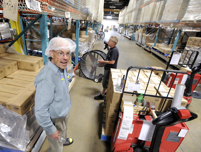 Bill Hetzel, plant manager, stands in the product warehouse of Tom’s of Maine in Sanford. He likens some of the ingredients to fine wines – expensive and sourced from specialty suppliers.