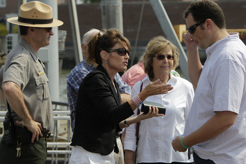 Forward, feminists: Sarah Palin (above, shown visiting the Statue of Liberty in June) and Rep. Michele Bachmann (below, on the campaign trail) are far removed from traditional feminists in their political views.