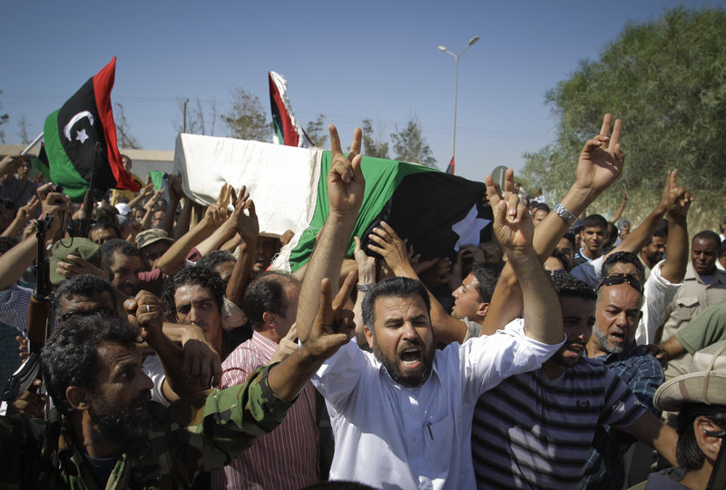 Libyans chant slogans during the funeral of the rebels’ slain military chief, Abdel-Fattah Younis, in the rebel-held town of Benghazi on Friday. Younis was killed under mysterious circumstances while in custody by rebels.