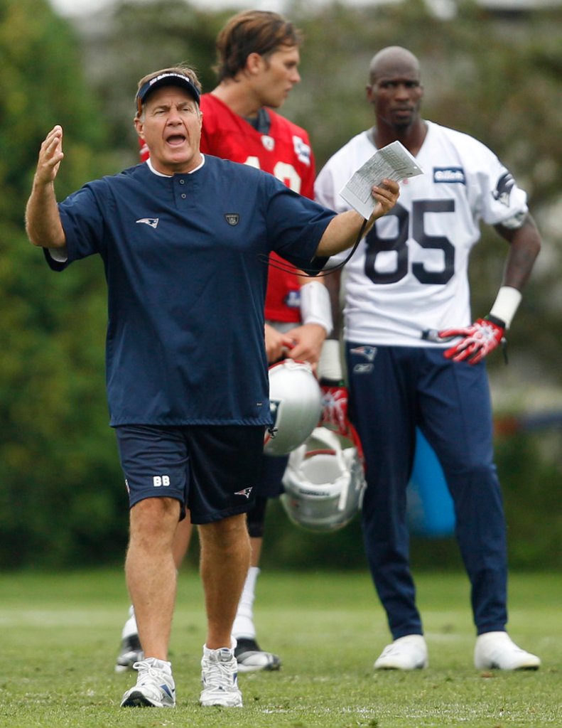That’s a serious-looking Chad Ochocinco, right, listening to Tom Brady, and that’s Coach Bill Belichick barking out instructions. The Patriots’ training camp has begun.