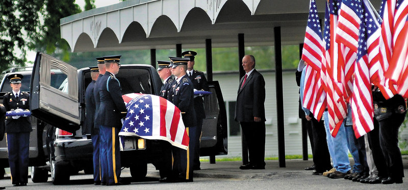 Members of the Maine Army National Guard on Friday carry the casket of Pfc. Tyler M. Springmann, 19, of Hartland, who was killed in Afghanistan on July 17.