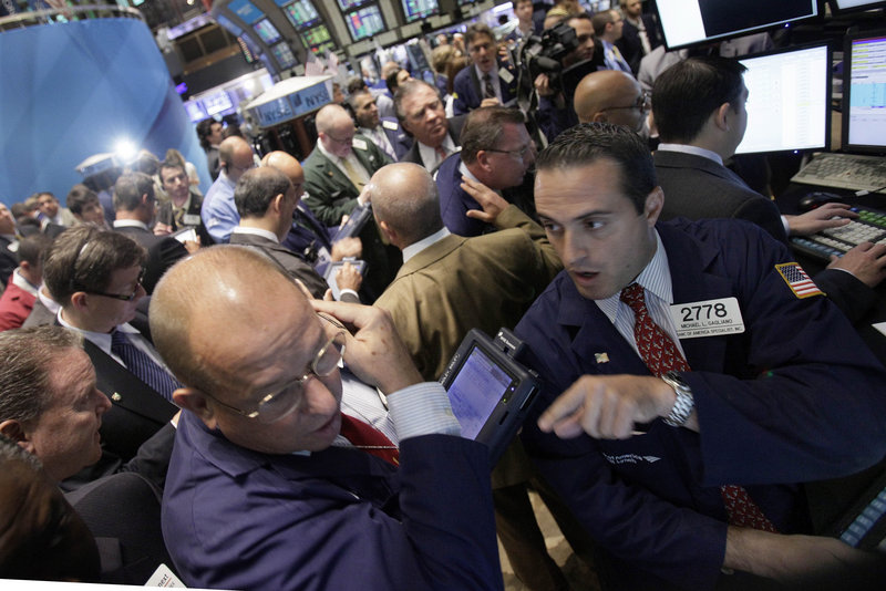 Michael Gagliano, right, directs trades Thursday at his post on the floor of the New York Stock Exchange. A financial planner in Florida says the recent market decline has forced him to “talk a lot of people off the rooftops.”