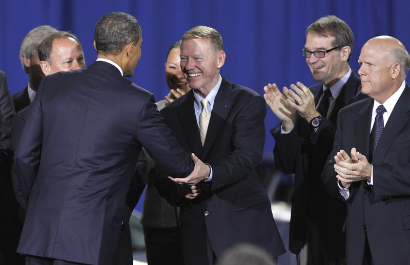 President Obama greets Alan Mulally, president and CEO of Ford, in Washington on Friday, where he announced new fuel efficiency standards for cars and light trucks.