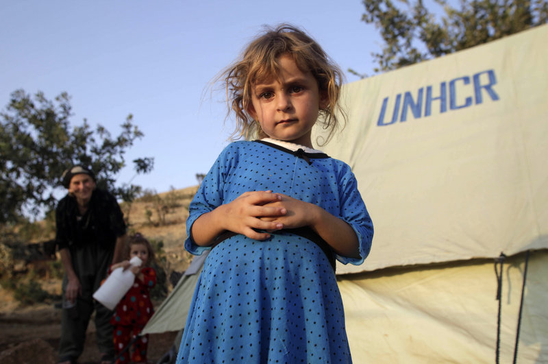 Solin Doher, 5, stands near her family’s tent this week at a camp for people displaced by fighting near Sone village in northern Iraq. A report on Iraq says the U.S. military is glossing over the country’s instability.