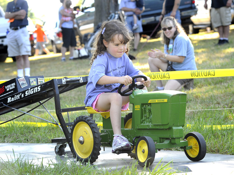 Six-year-old Caroline Chessie of Shapleigh gets down to business in the “pedal pull” Saturday at the Eliot Antique Tractor & Engine Show.