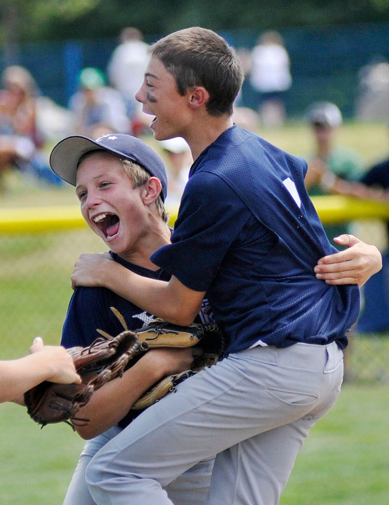Noah Pellerin, right, and Jack Snyder lead the celebration Saturday after Snyder caught a fly to right, ending the game and giving Yarmouth a 6-3 victory against York in eight innings in the Little League state final at Payson Park.
