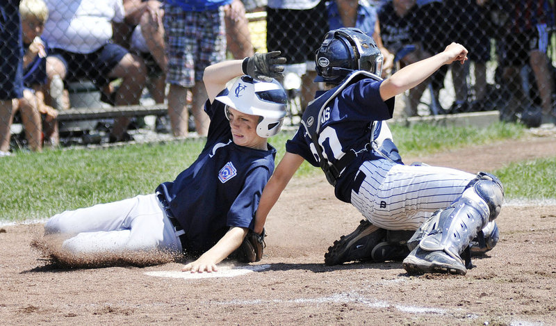 Joe DeFusco of Yarmouth attempts to score but is tagged out by York catcher Sam DesMarais during the Little League state final at Payson Park.