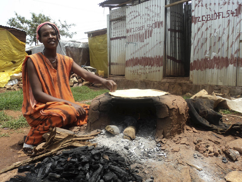 An Eritrean woman cooks in the Mai-aini refugee camp in northern Ethiopia on Friday, one of thousands fleeing famine.