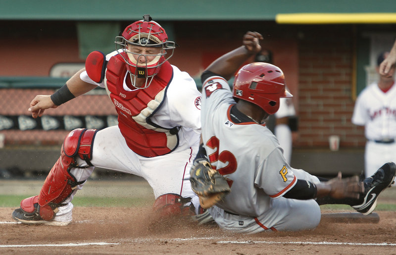 Portland catcher Tim Federowicz applies the tag but doesn't have the ball, which got past him, allowing Altoona's Quincy Latimore to score in the fourth inning of the Curve's 5-1 victory Saturday night at Hadlock Field.