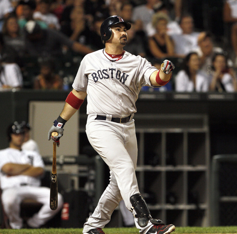 Adrian Gonzalez of the Boston Red Sox watches the flight of the ball Saturday night as it leaves the park in the ninth inning of the 10-2 victory against the Chicago White Sox.