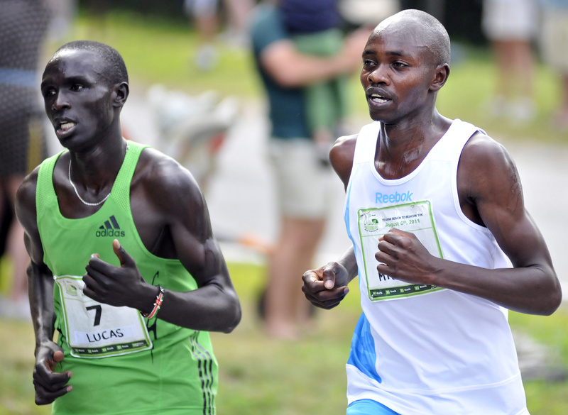 Lucas Rotich, left, runs alongside Micah Kogo near the halfway mark. Kogo surged into the lead soon thereafter, leaving Rotich to settle for second place.