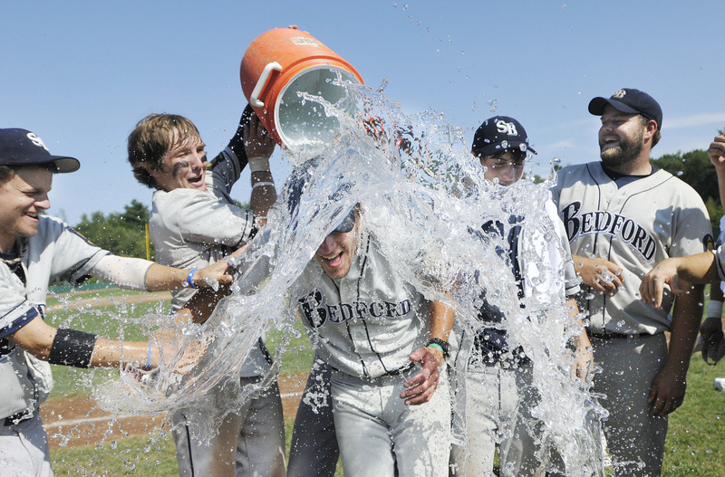 Bedford Post Coach Tim Conway gets a shower after the game, courtesy of his players, during the team’s championship celebration. Bedford moves on the American Legion World Series in Shelby, N.C.