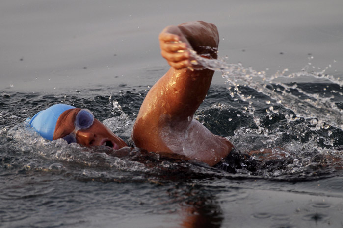 American endurance swimmer Diana Nyad , 61, swims in Cuban waters, offshore Havana, Cuba, Sunday, Aug. 7, 2011. Nyad jumped into Cuban waters Sunday evening and set off in a bid to become the first person to swim across the Florida Straits without the aid of a shark cage. (AP Photo/Franklin Reyes)