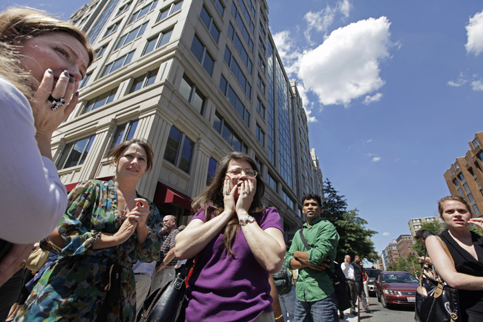 Office workers gather on the sidewalk in downtown Washington today, moments after a 5.9 magnitude tremor shook the nation's capital.