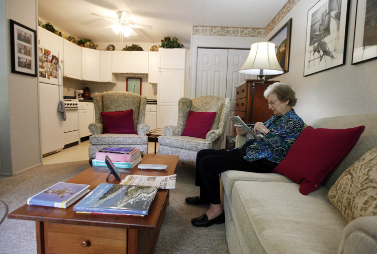Jane Merrill as she works a crossword puzzle in her apartment in the home of her son, William Merrill, in Carmel, Ind. The Merrill family had their two-car garage renovated to create a mother-in-law suite for Jane.