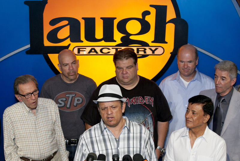 Comedian Paul Rodriguez, at podium, expresses the comedians' support Friday for Jerry Lewis to be reinstated as host of the annual Muscular Dystrophy Association Telethon. With him are, from left, Norm Crosby, Jason Stuart, Angelo Tsarouchas, Larry Miller, Jamie Masada (front) and Tom Dreesen.
