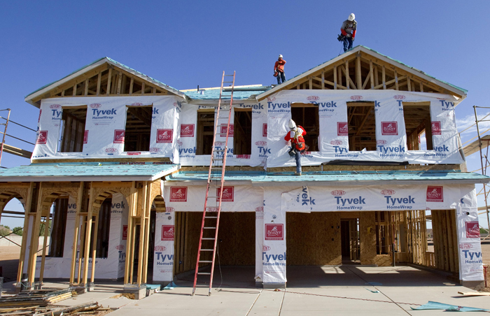 Builders frame a new home in Queen Creek, Ariz., on Monday. The number of people who bought new homes fell for the fourth straight month.