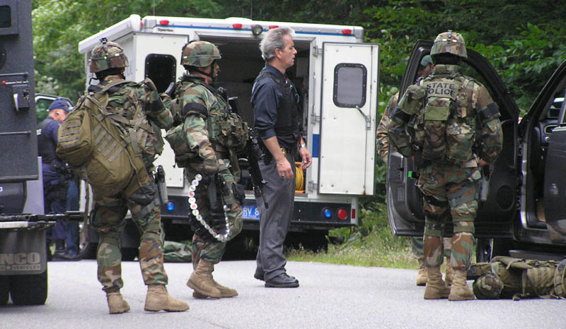 Staff photo by Scott Monroe State and local police converge on North Pond Road in Winslow Thursday afternoon where a man barricaded himself in a home and threatened to kill himself.