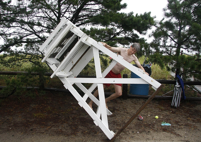 Steve Opre, a lifeguard with the Ferry Beach Park Association, secures a lifeguard stand alongside Surf Street in Camp Ellis this morning. Opre, along with fellow lifeguards Kate Campbell Strauss and Eli Grober, took a swim to test the waters and closed the beach after determining it unsafe.