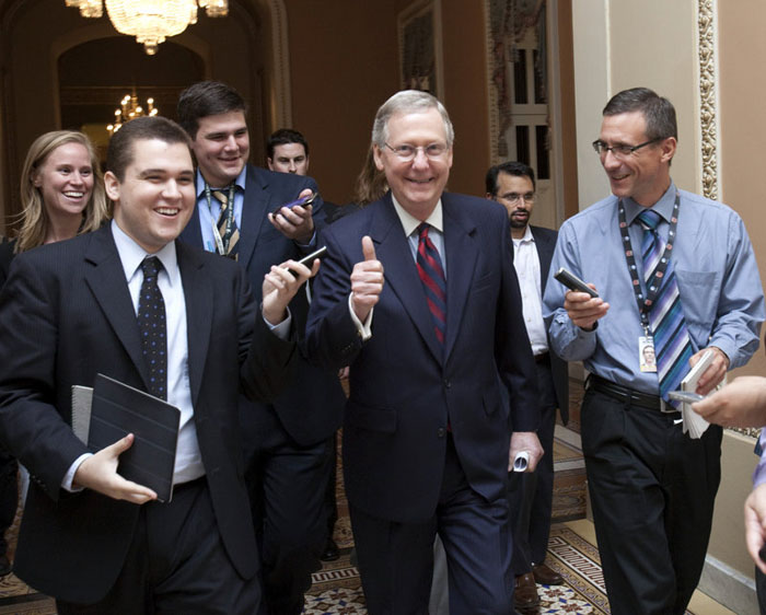 Senate Minority Leader Mitch McConnell, R-Ky., is all smiles as he walks to the Senate floor to announce that a deal has been reached on the debt ceiling on Capitol Hill on Sunday.