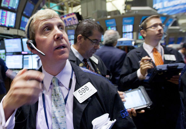 Traders monitor the action on the floor of the New York Stock Exchange today.