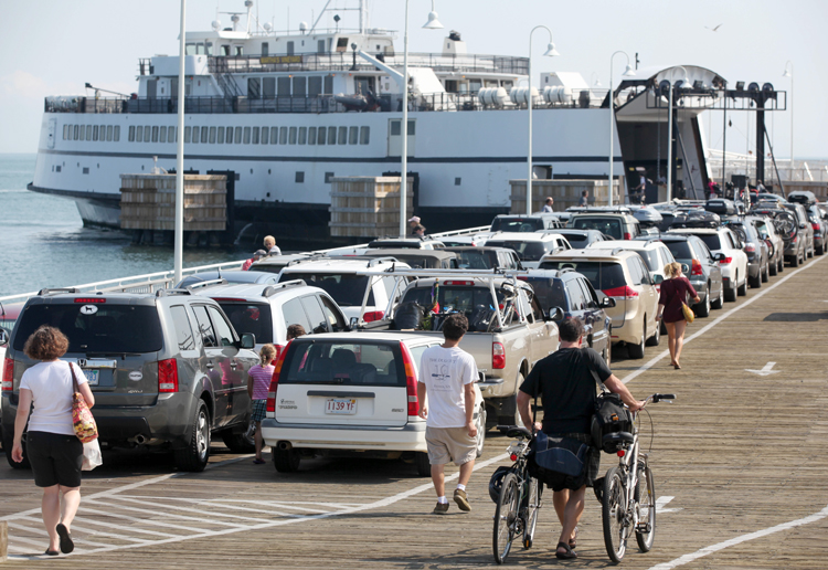 Passengers with cars and bicycles prepare to board a ferry departing Martha's Vineyard today. The Steamship Authority, which operates ferries between the island and the mainland, has added additional vessels to the schedule in anticipation of the arrival of Hurricane Irene.
