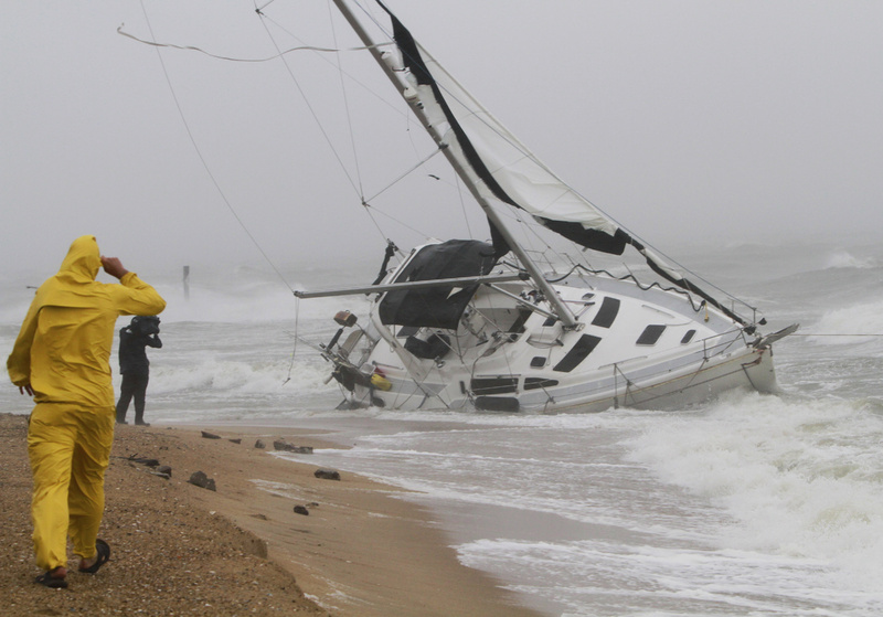 A stranded sailboat founders in the surf along the Willoughby Spit area of Norfolk, Va., as Hurricane Irene hits Norfolk, Va., today. The live-aboard couple attempted to outrun the storm and got caught up in the high surf and wind. They were rescued by local fire and rescue personnel.