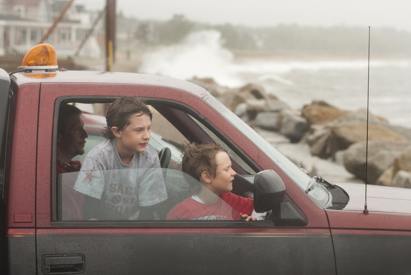 Cameron and Christian Schaffer, 10 and 7 of Saco check out the waves from inside the family truck at high tide during Tropical Storm Irene along Surf Street in Camp Ellis, Saco, today. Shortly before a wave sprayed the brothers inside the window.