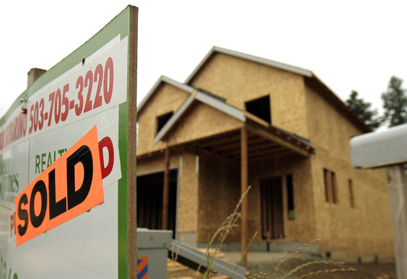 A single-family home under construction in Portland, Ore., boasts a sold sign in July. Lawrence Yun, chief economist at the National Association of Realtors, said that now would be the worst possible time to change the mortgage interest deduction because it would further depress demand in the struggling housing sector.