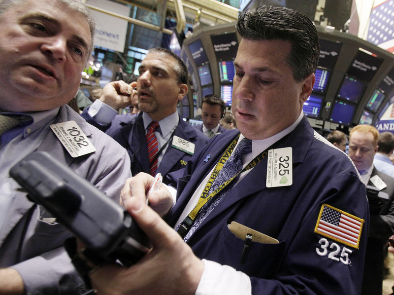 Traders check New York Stock Exchange data in this 2011 file photo.