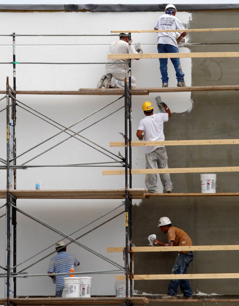 Workers resurface the exterior of a store at a shopping plaza in Mayfield Heights, Ohio. Construction spending rose in July but remains at half the pace considered healthy by most economists.