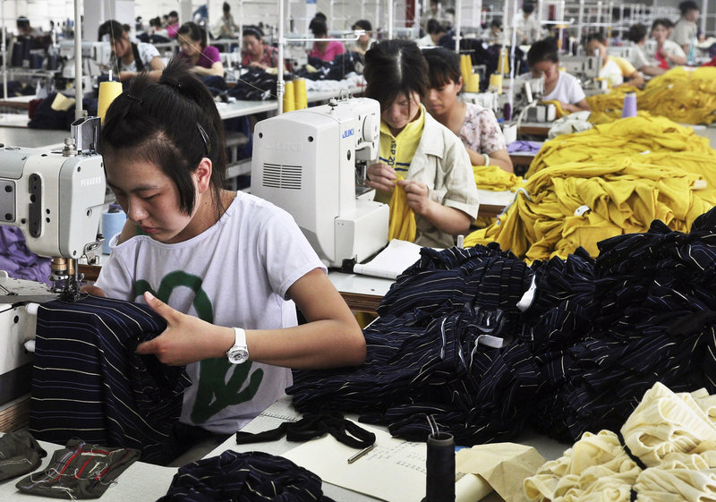 Factory workers stitch bamboo-fabric clothing in China's Shandong province. Sluggish U.S. growth has hurt exporters of Chinese products.