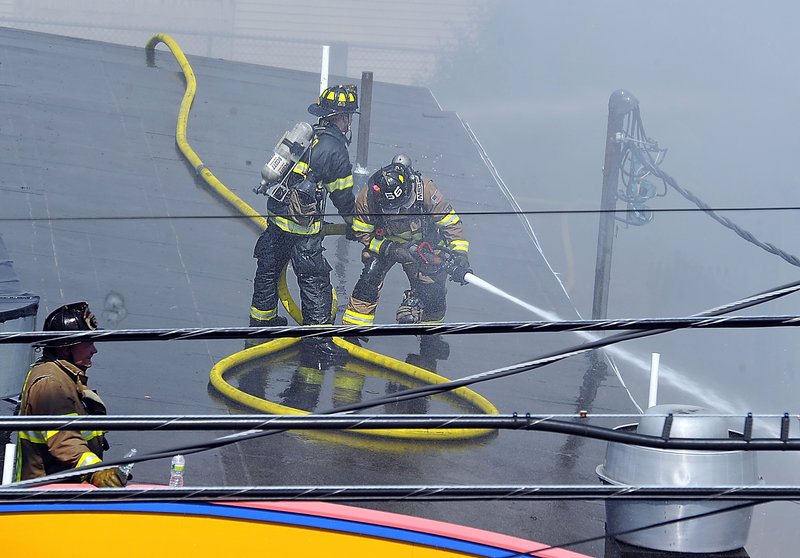 Firefighters battle the blaze from a rooftop near the Galaxy. The 78-year-old building, which has been renovated many times, has an assessed value of $573,800, including $263,000 for the building.