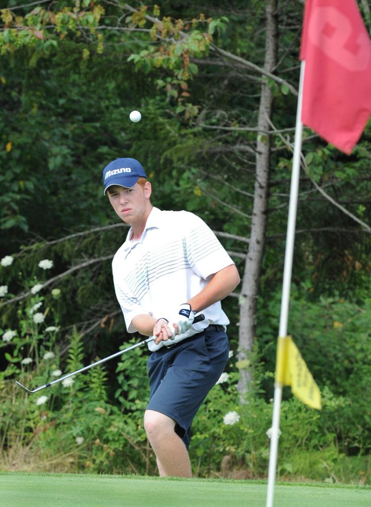 Joe Walp hits a shot toward the pin at the ninth hole Tuesday in the first round of the Maine Junior Amateur Championship. Walp, the defending champion, shot 73.
