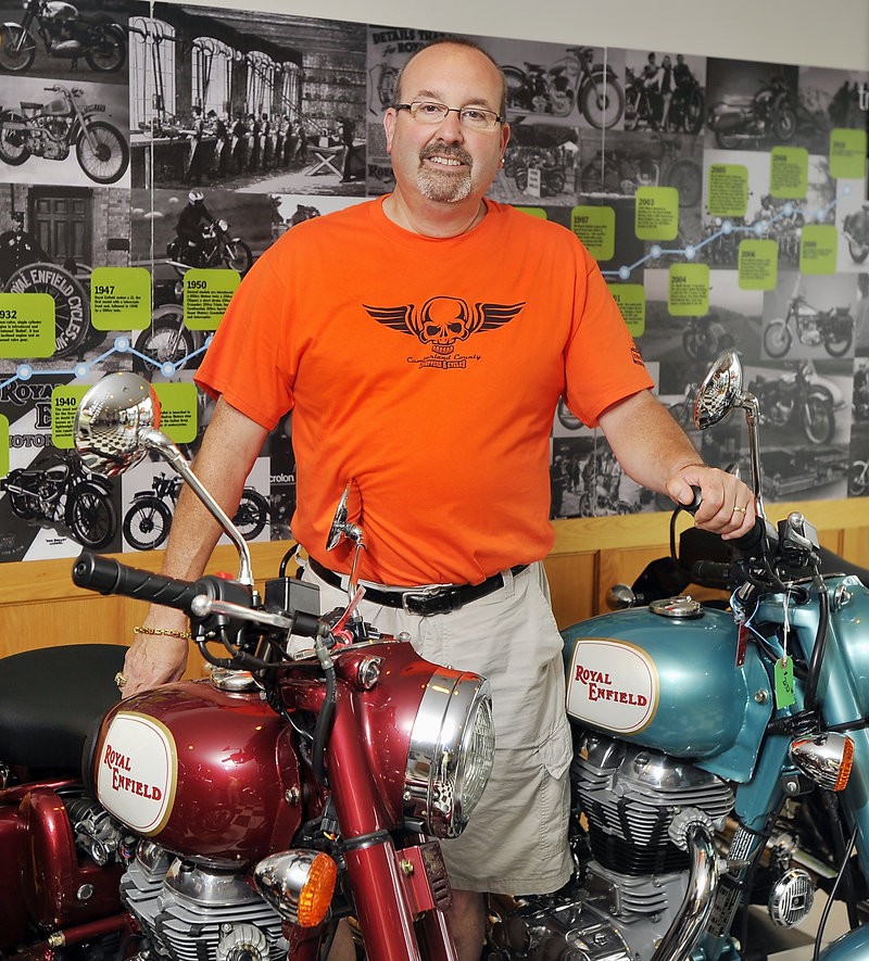 Pete Gordon, co-owner of Cumberland County Choppers, stands among his Royal Enfield Classics.