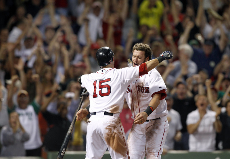Jarrod Saltalamacchia, right, celebrates with Dustin Pedroia after Saltalamacchia scored in the bottom of the ninth to give Boston a 3-2 win.
