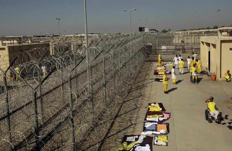 Detainees mingle outside their cell block at Camp Cropper, the U.S. detention facility in Baghdad, in 2008. A former contractor for the U.S. military says he was repeatedly abused while held at the camp for nine months.