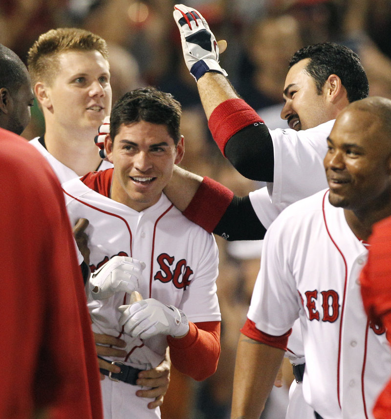 Jacoby Ellsbury is congratulated by his teammates after he hit a home run in the bottom of the ninth inning to give Boston a 4-3 win over the visiting Indians on Wednesday.