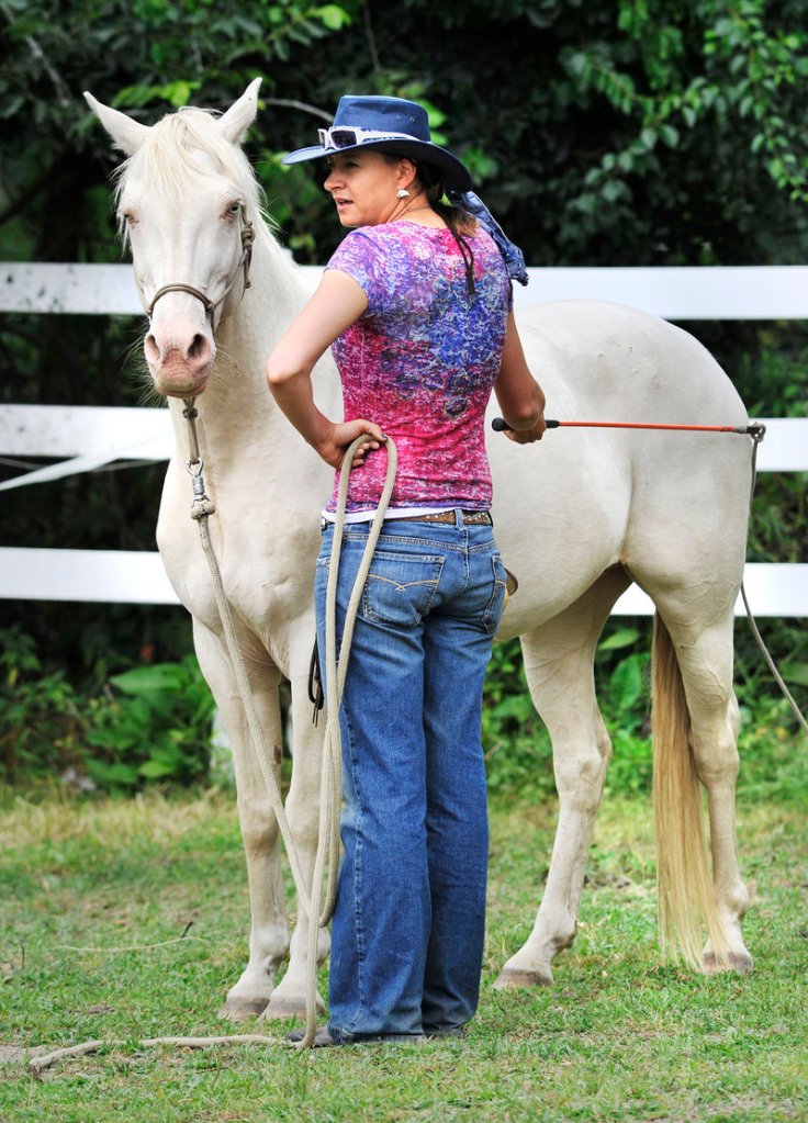 Farrah Green, a South Dakota trainer, works with one of the horses that will participate in a weekend performance piece with human dancers at a farm in Pownal. Green also encourages the human participants in the program to think like horses. "Everything comes down to you," she told them.