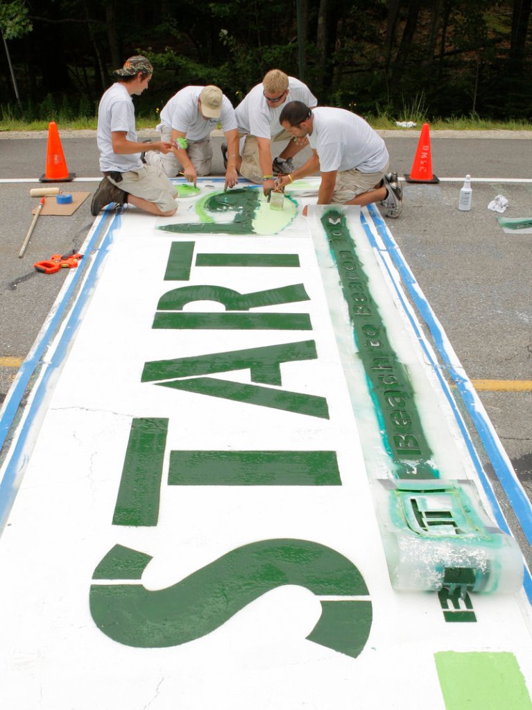 The starting line for the Beach to Beacon in Cape Elizabeth will be easy to spot Saturday thanks to the paint work done Thursday by, left to right, Ryan McGillivray, Matt Tobin, Eli Madsen and Mike DiDonato.